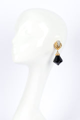 Diamond drop earrings by St. John on white background on mannequin @recessla