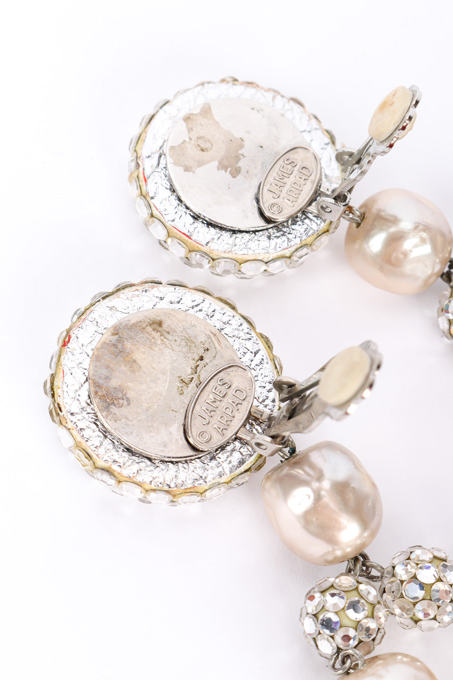Pearl drop earrings by James Arpad on white background carotuches @recessla