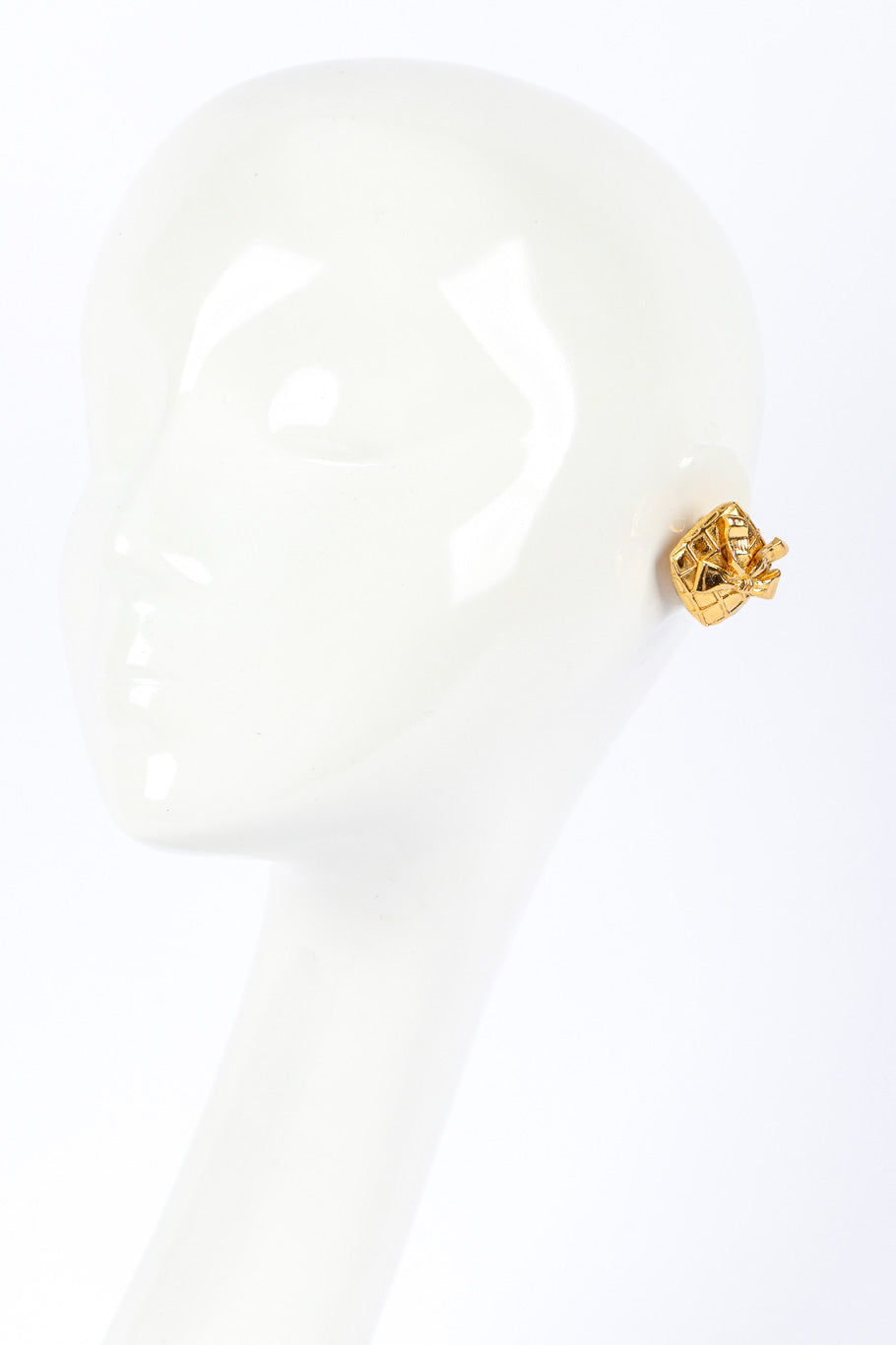 Quilted Bow Earrings by Chanel on white background on mannequin head @recessla