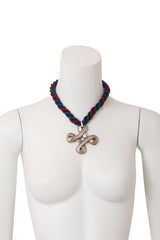 Twisted cross pendant necklace on mannequin @ Recess LA