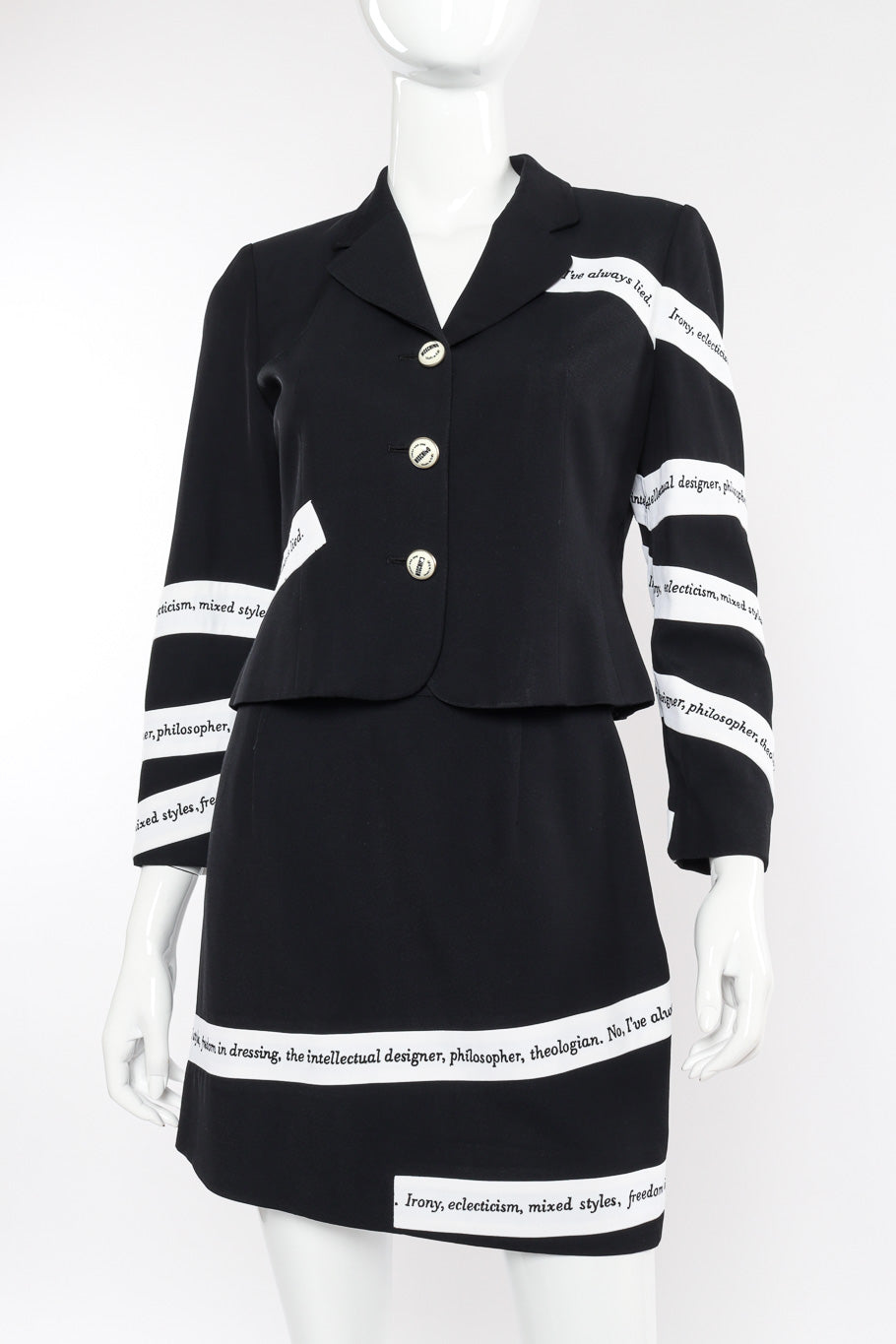 Irony of Design Text Blazer & Skirt Suit by Moschino on mannequin front close  @recessla