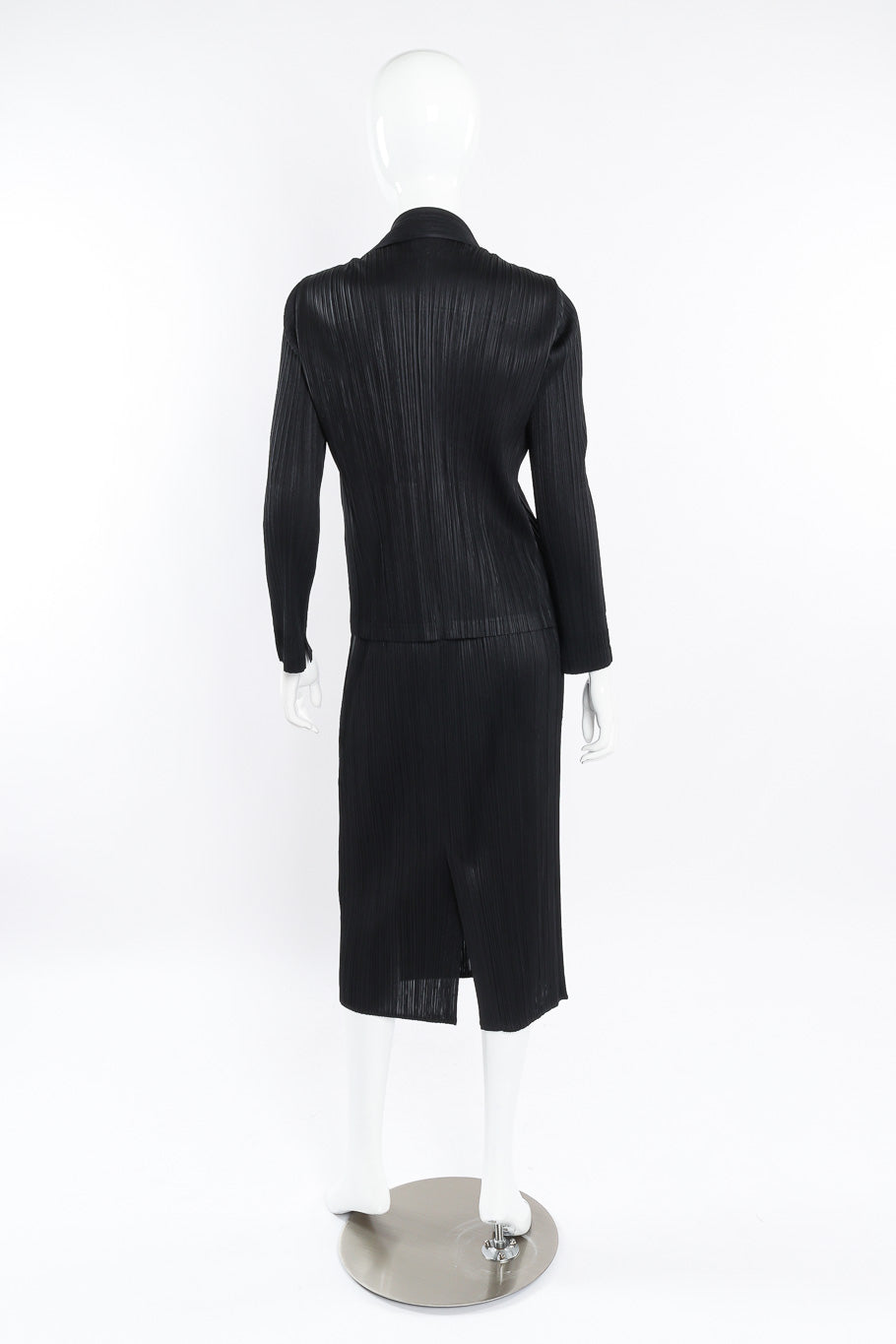 Pleated skirt, top, and jacket set by Issey Miyake on mannequin back @recessla