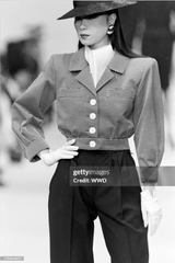 striped jacket by Saint Laurent on model on 1986 runway via Getty