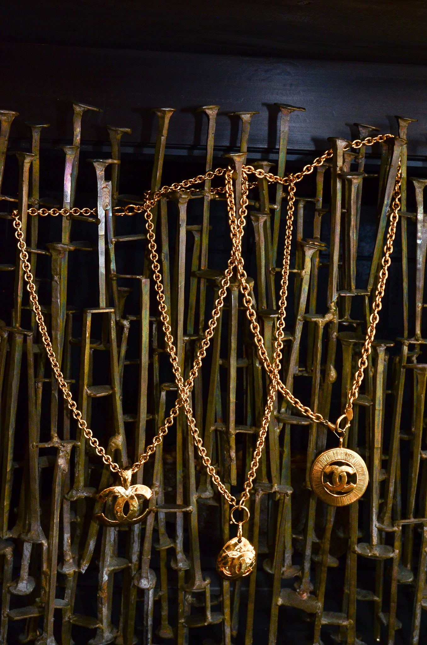 Vintage Chanel Long Quilted CC Logo Drop Pendants on brutalist metalwork at Recess Los Angeles