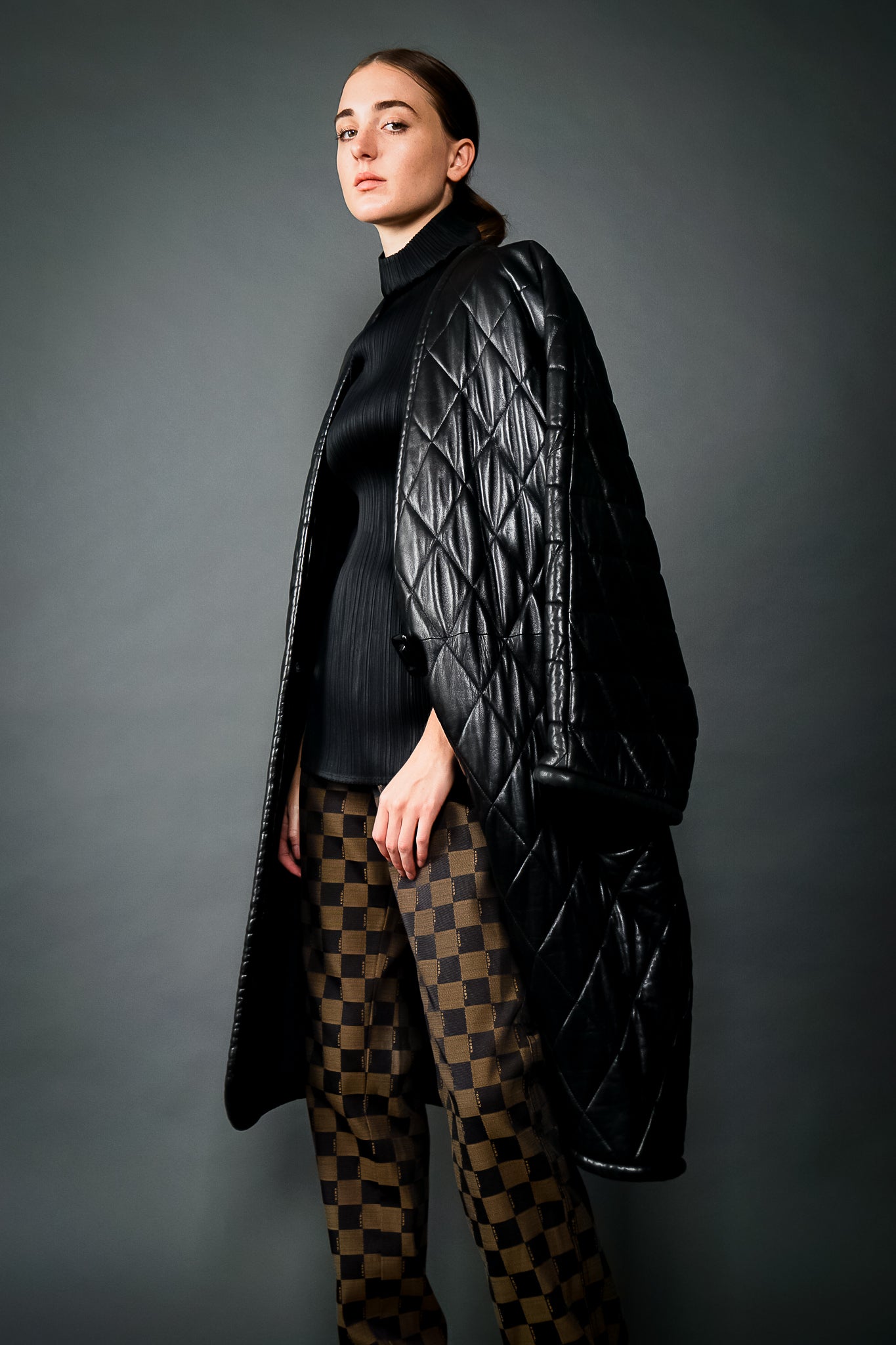 Girl in Vintage Anne Klein Quilted Leather Cocoon Coat w/ black top & Fendi pant at Recess LA