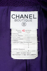 Vintage Chanel bouclé jacket label on purple