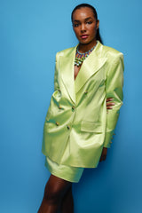 Brittany Hampton in Vintage Escada Satin Double Breasted Skirt Suit on blue at Recess Los Angeles