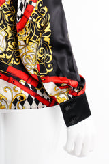 Vintage Escada Baroque Belt Print Mock Neck Blouse on mannequin sleeve at Recess Los Angeles