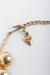 Recess Vintage Mosell stamped heart charm and chain hook closure on Grey Background