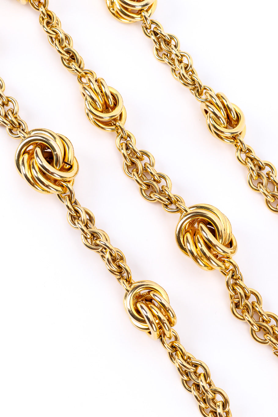 Gold metal vintage chain belt on white background three strands close @recessla