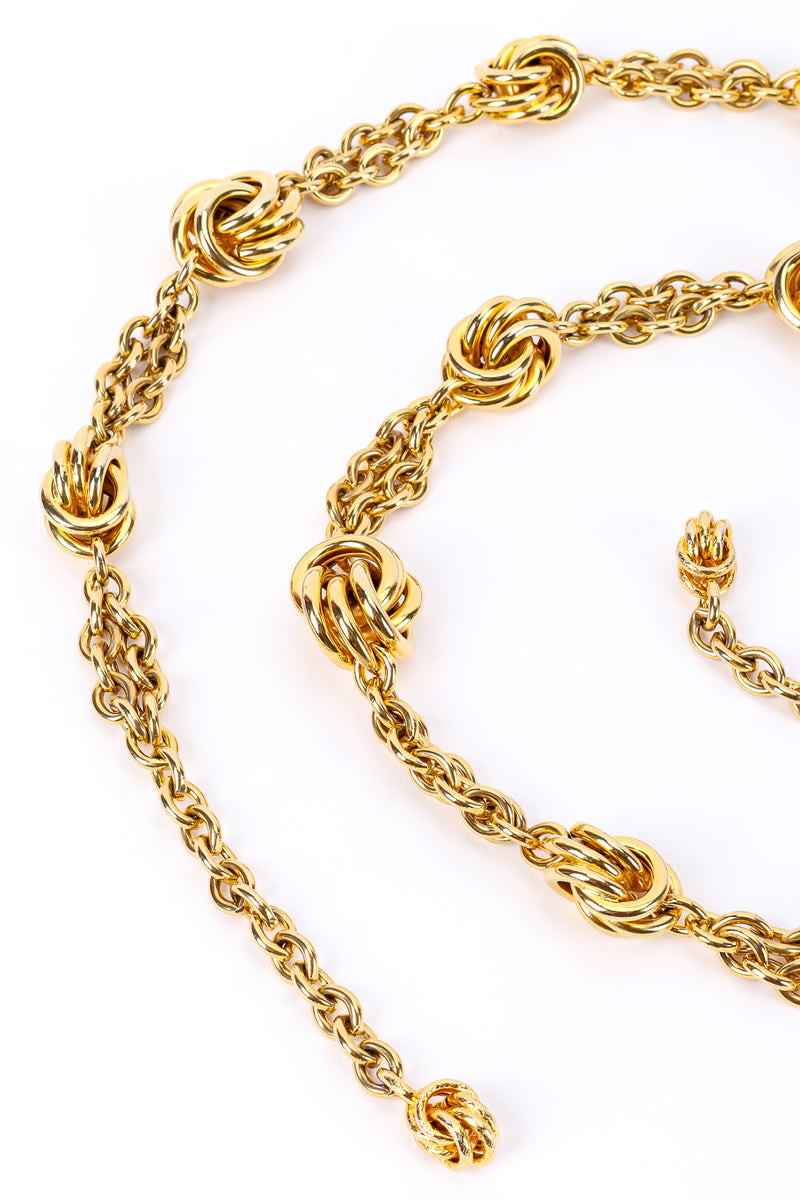 Gold metal vintage chain belt on white background in swirl side close @recessla