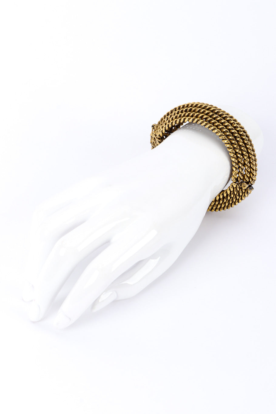 Cuff bracelet by Kenneth Jay Lane on white background on mannequin hand far @recessla