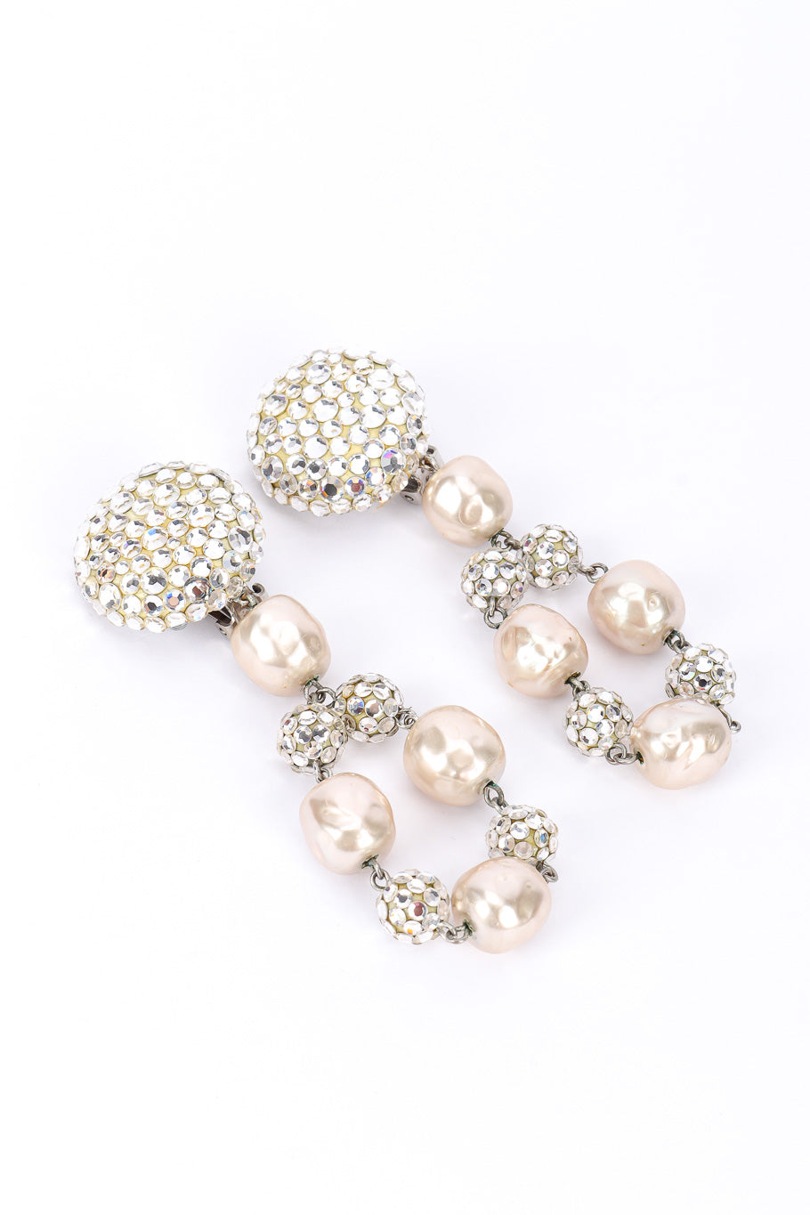 Pearl drop earrings by James Arpad on white background diagonal @recessla