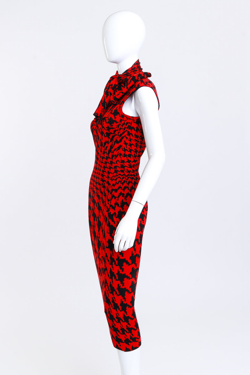 red and black houndstooth dress You can't go wrong with a timeless, classic black/white houndstooth print and bright red accessories! I'm loving the straight, midi style of this dress, the contrasting trim, and the marble-like buttons. The