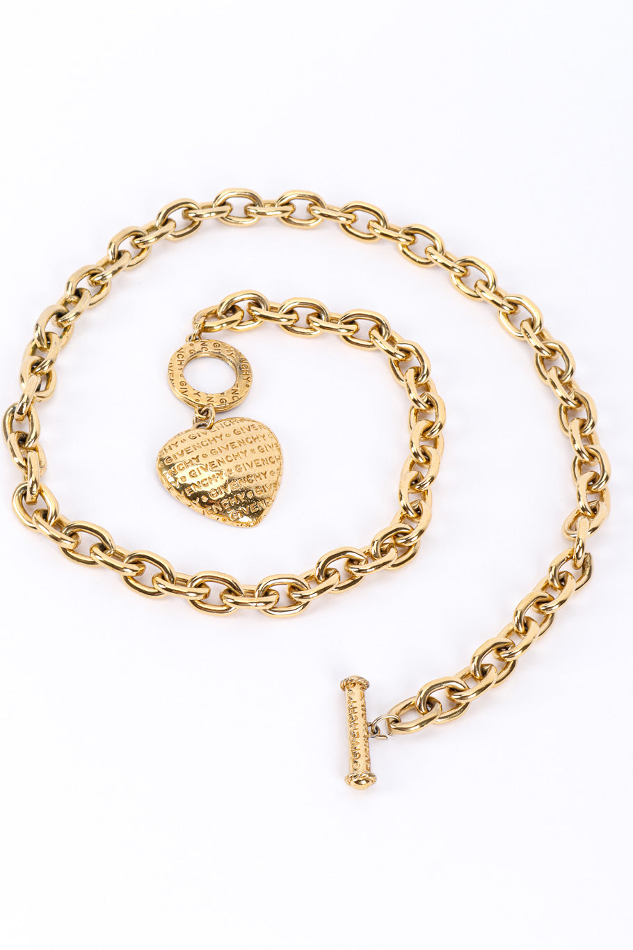 Heart charm necklace by Givenchy on white background in swirl @recessla