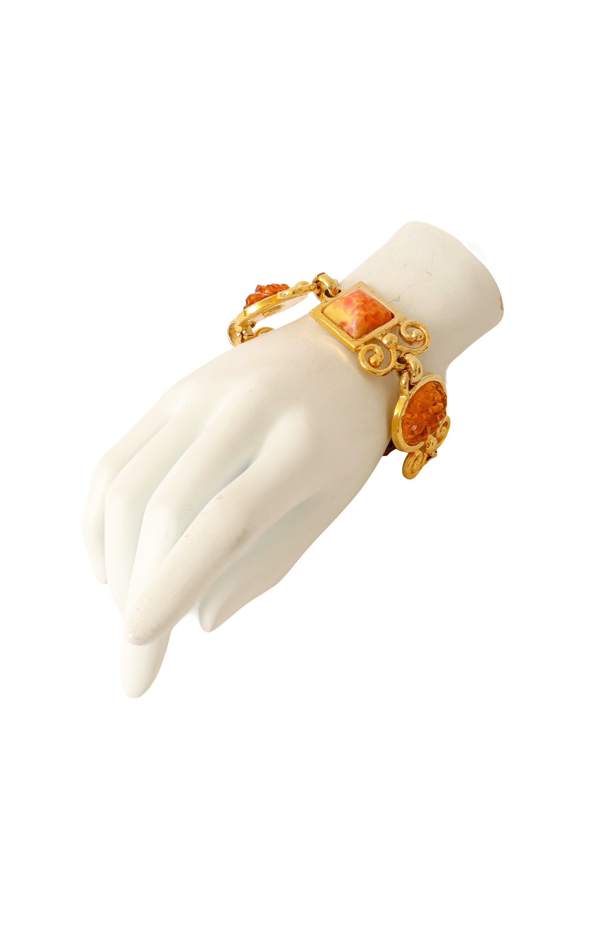 Ornate link bracelet with textured amber-tone glass panels and gold scrollwork by Shadow Paris on mannequin @ Recess LA 
