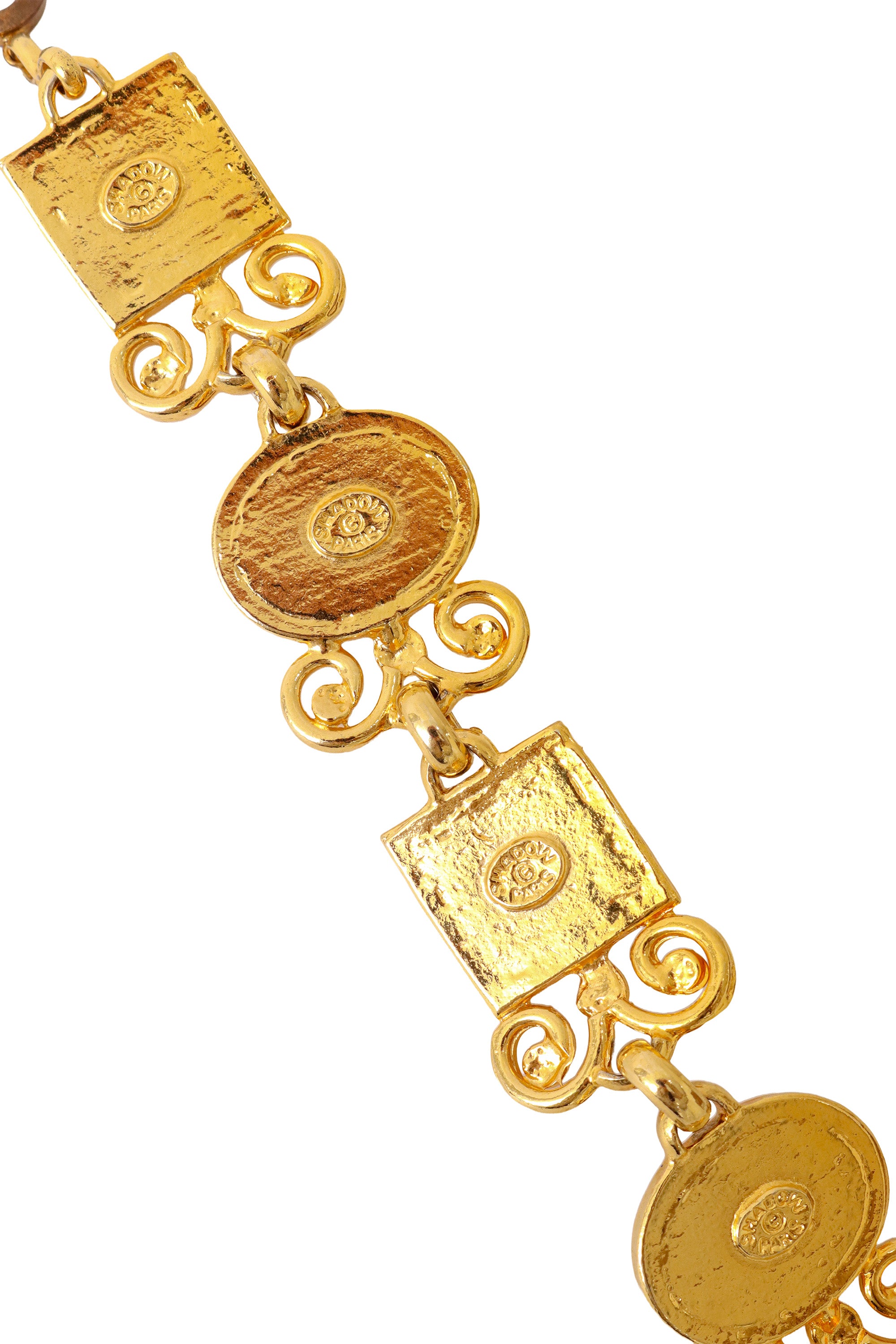 Ornate link bracelet with textured amber-tone glass panels and gold scrollwork by Shadow Paris back signatures @ Recess LA 