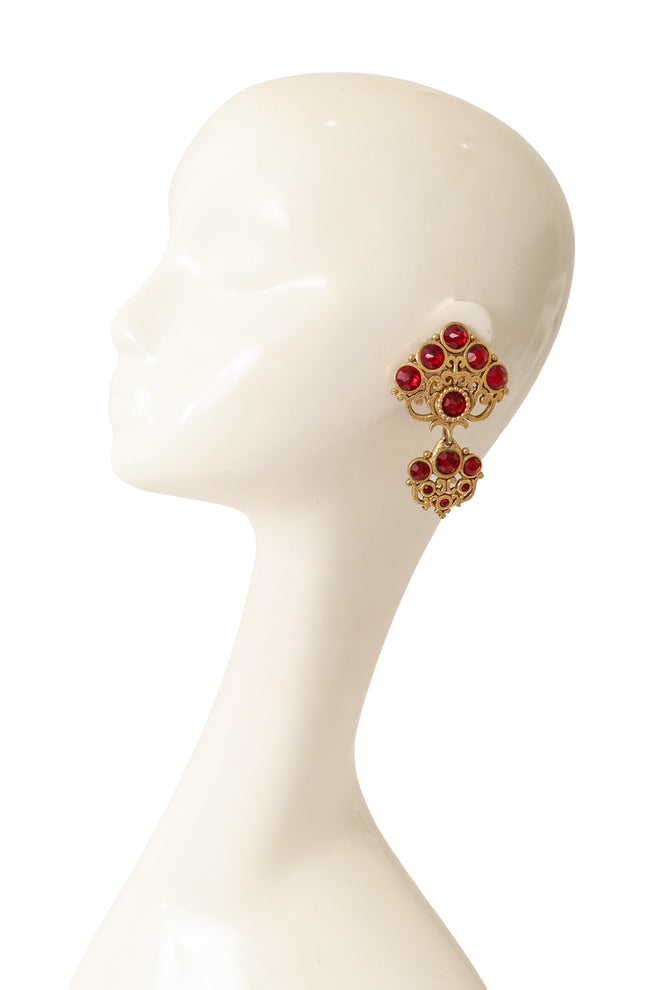 Large ornate crystal drop earrings with layered gold scrollwork and red glass stones by Abbey Road on mannequin @ Recess LA
