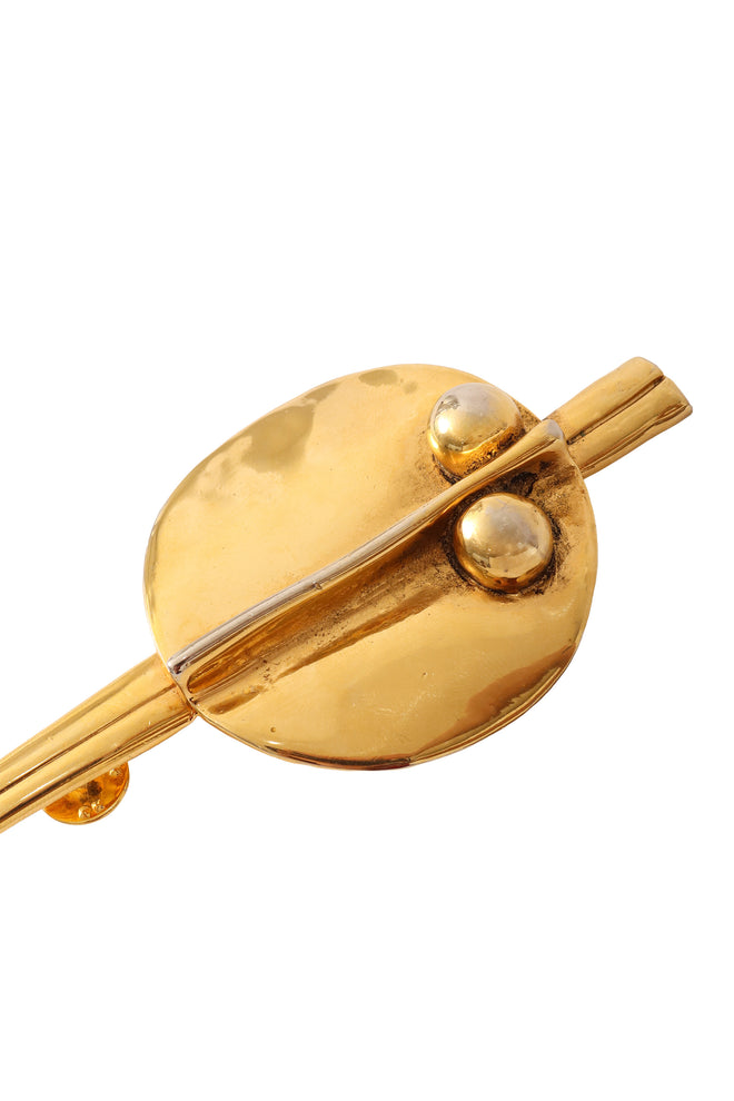 Golden abstract dagger plate pin by Sidney Cannon plate up close @ Recess LA 