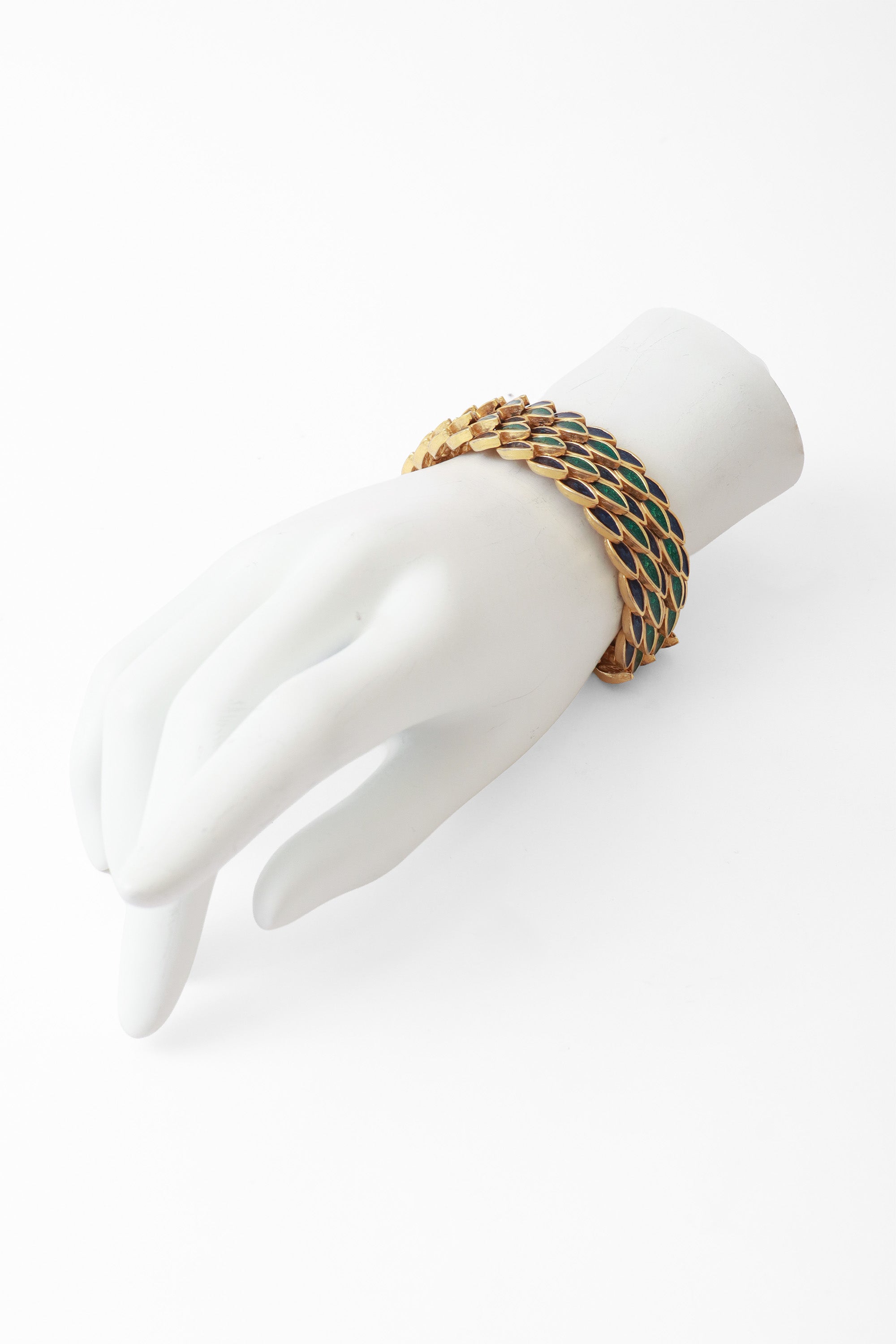 Gold bracelet with green and blue repeating leaf motif by DG on Mannequin @ Recess LA