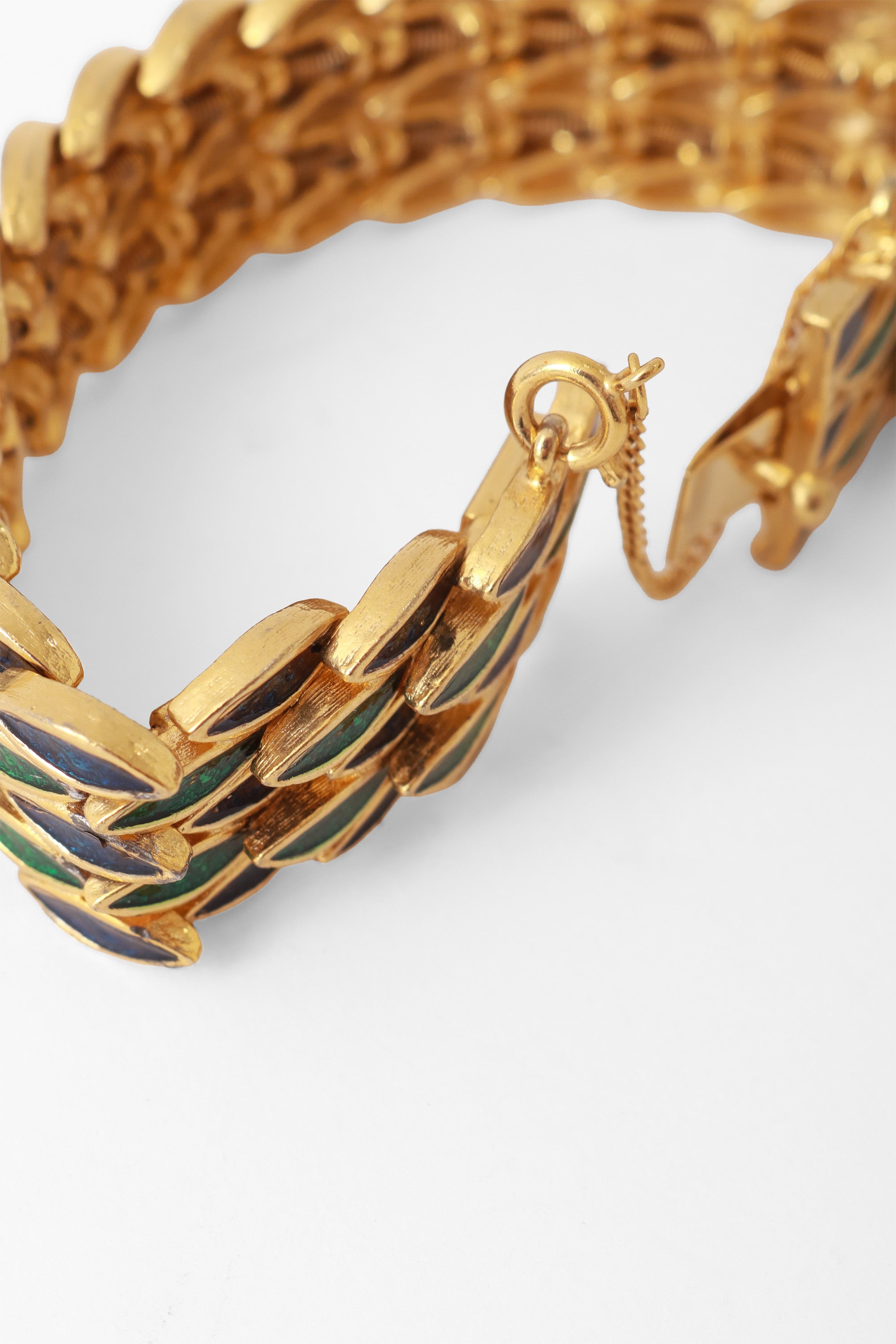 Gold bracelet with green and blue repeating leaf motif by DG safety chain  close @ Recess LA