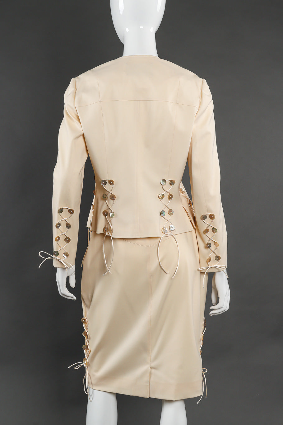 Skirt suit by John Galliano on mannequin back @recessla