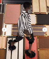 Louis Vuitton Monogram Fan Bag on 2025 runway on model in striped shirt