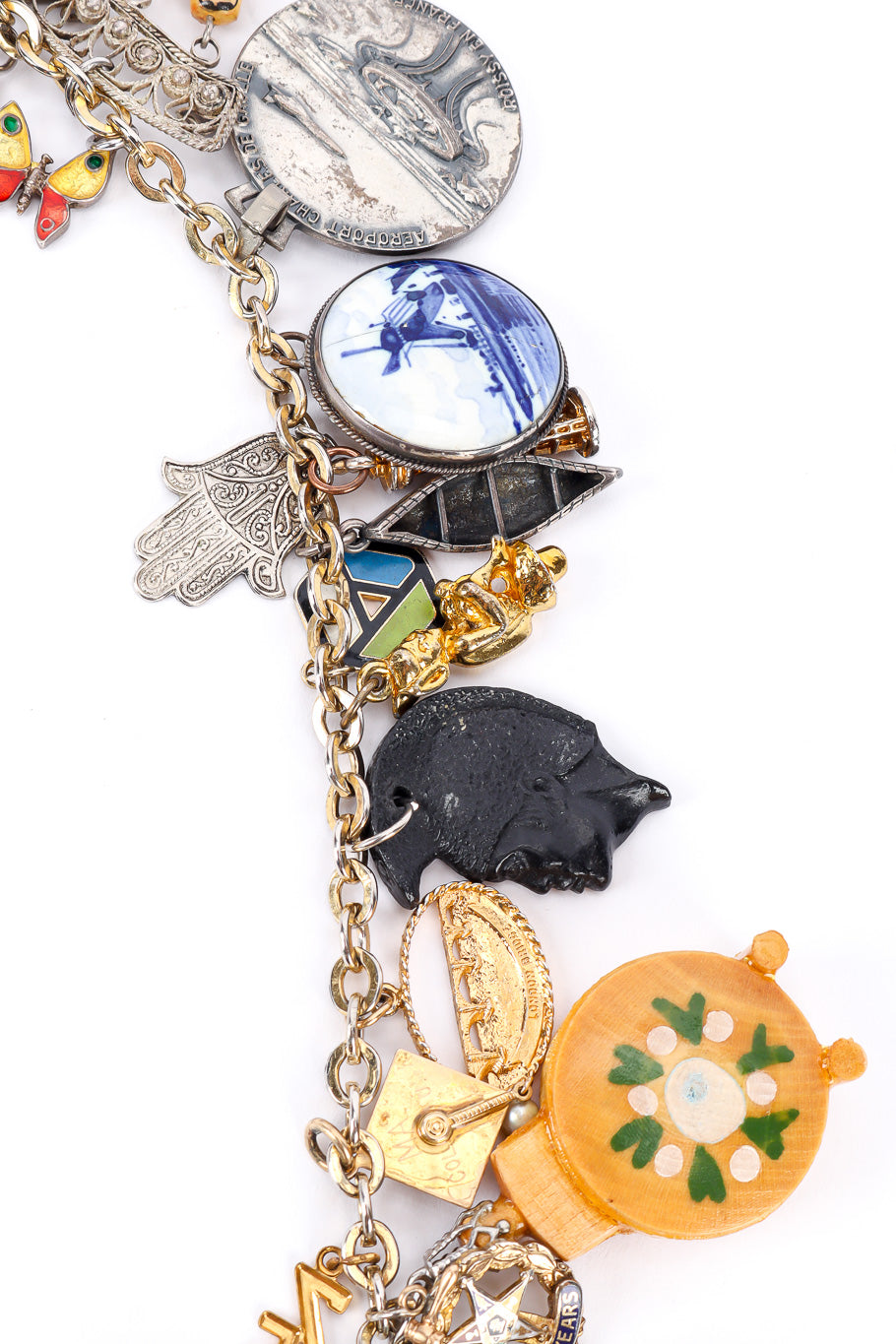 Charm necklace by Monet on white background windmill hamsa and assorted charms @recessla