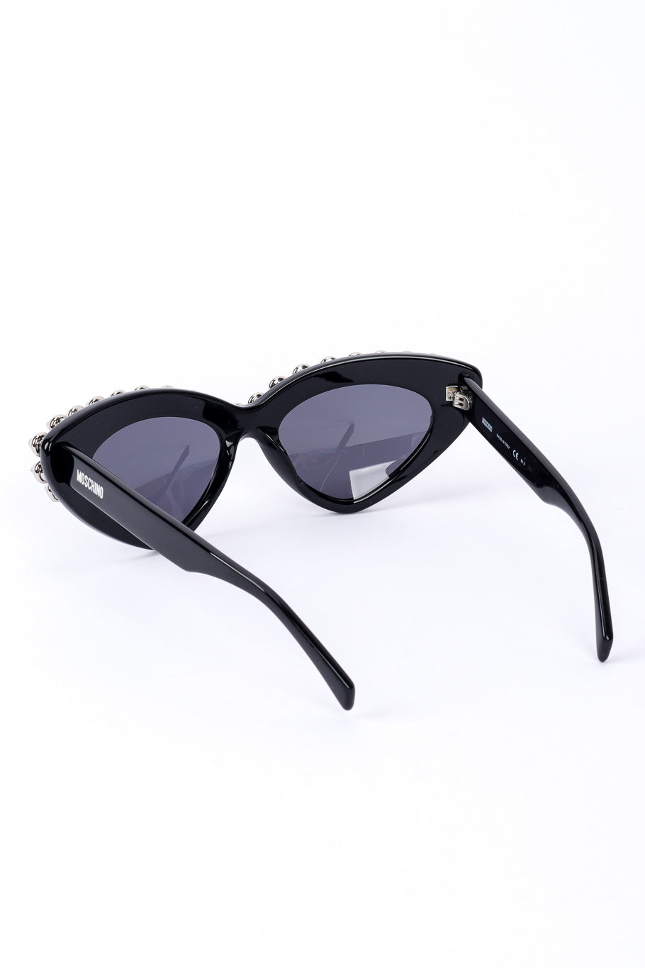 Spiked sunglasses by Moschino on white background inside lenses @recessla