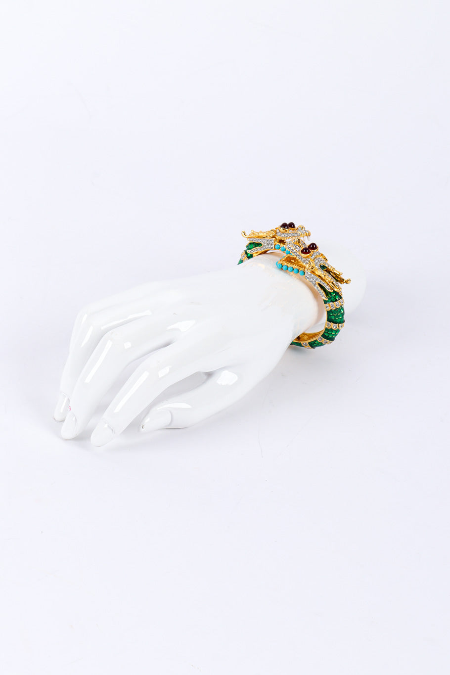 Dragon bracelet by Kenneth Jay Lane on white background on mannequin hand far @recessla