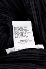 Pleats Please Issey Miyake Pleated Multi-Wrap Poncho II care instruction label closeup @Recessla