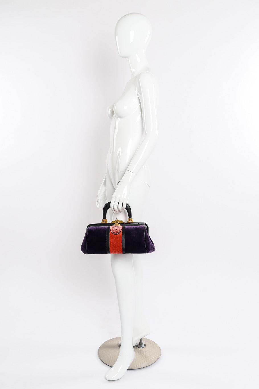 Velvet handbag by Roberta di Camerino on white background held by mannequin @recessla