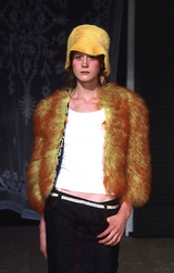 Fur bucket hat by Dolce & Gabbana in yellow on model on runway