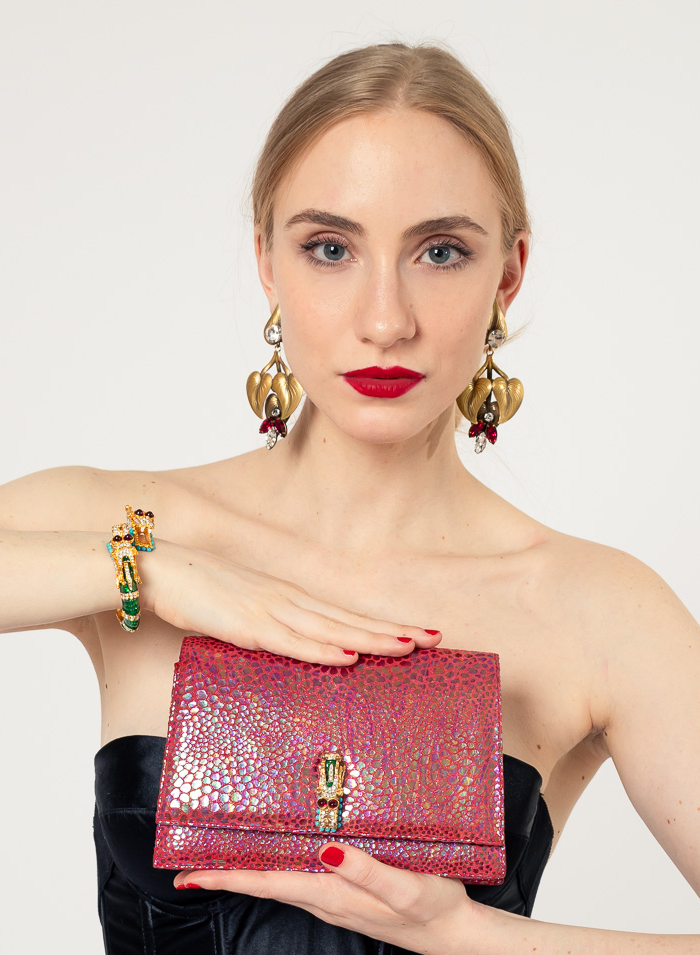 Leaf earrings by Joseff of Hollywood on white background on model holding bag @recessla