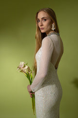 Gown on model in front of green background holding flowers @recessla