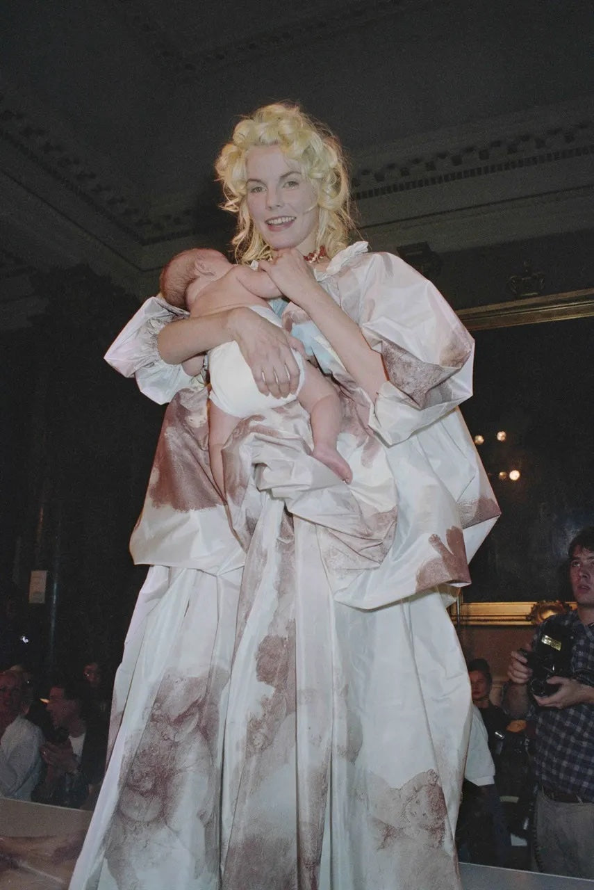 draped cherub dress by Vivienne Westwood on model with baby on 1991 runway