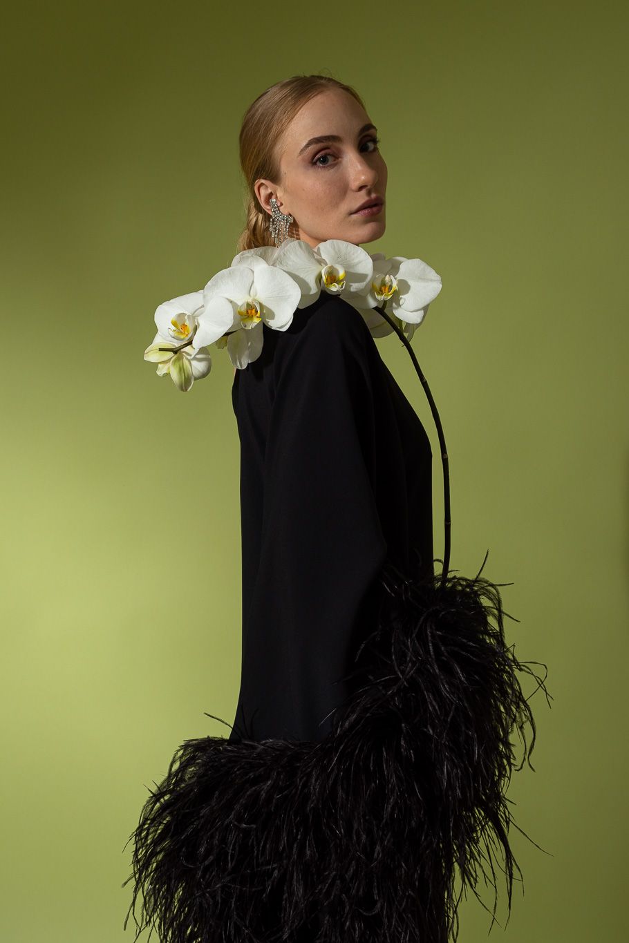 Dress on model holding orchid in front of green backdrop @recessla
