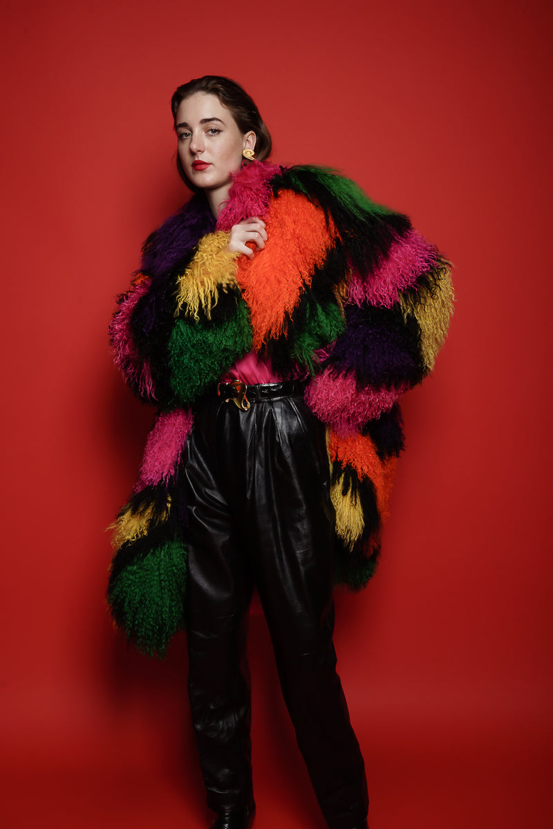 Girl in Vintage Neiman Marcus Rainbow Mosaic Mongolian Fur Coat on red background @ Recess LA