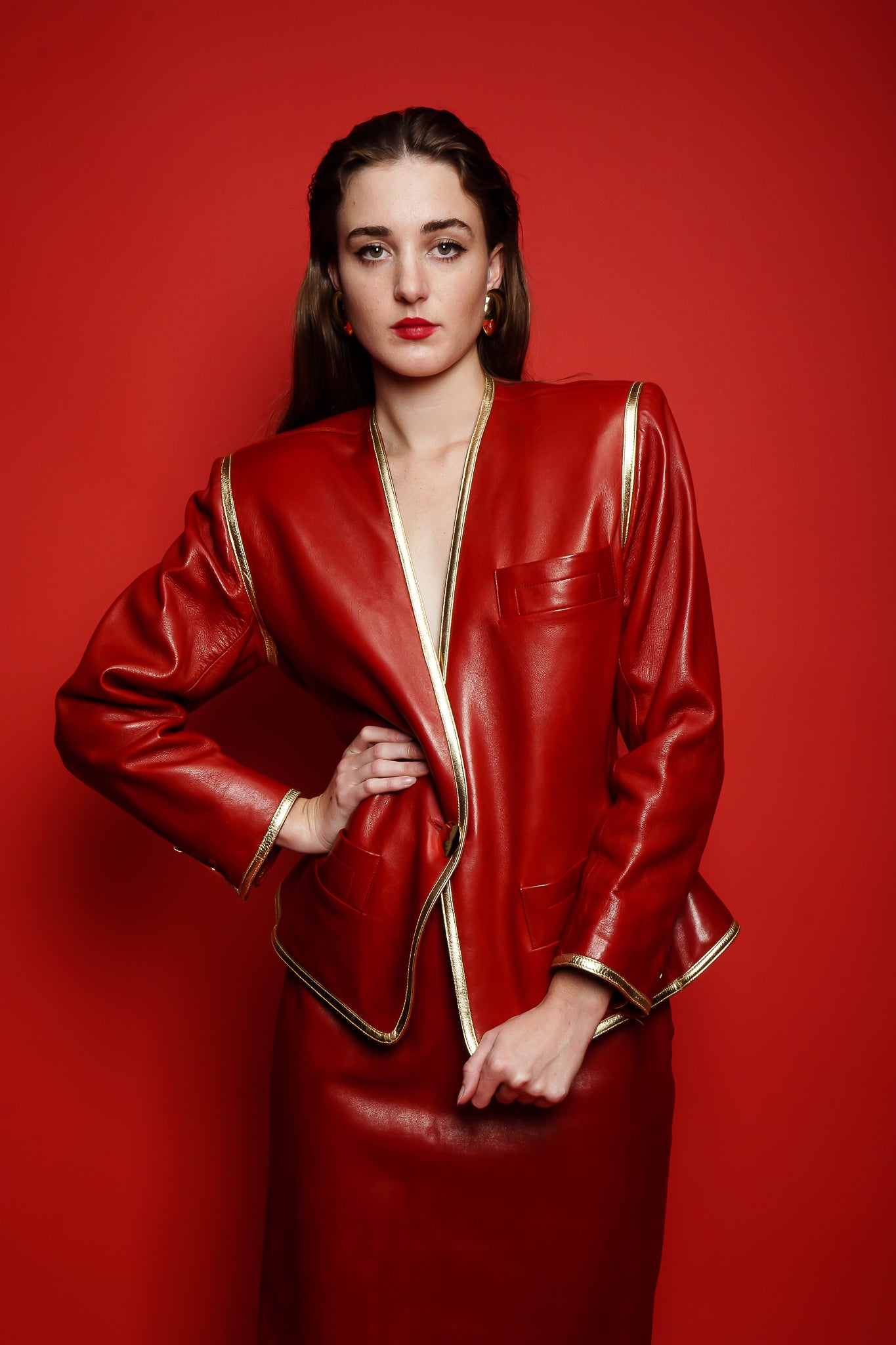 girl in Vintage YSL Yves Saint Laurent 1988 Red Leather Skirt Suit on red paper at Recess LA