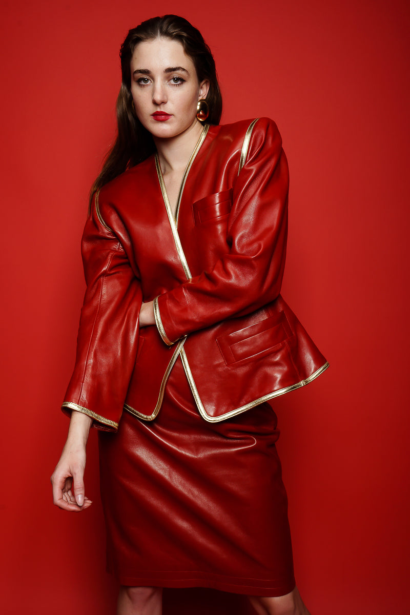 girl in Vintage YSL Yves Saint Laurent 1988 Red Leather Skirt Suit on red paper at Recess LA