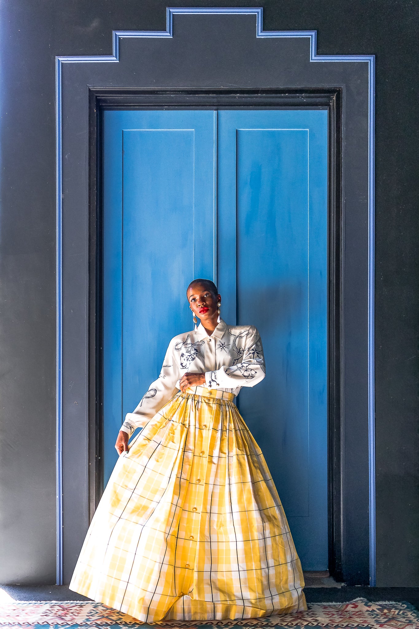Monica Ahanonu in Vintage Escada Plaid Taffeta Ball Skirt with blue door at Recess Los Angeles