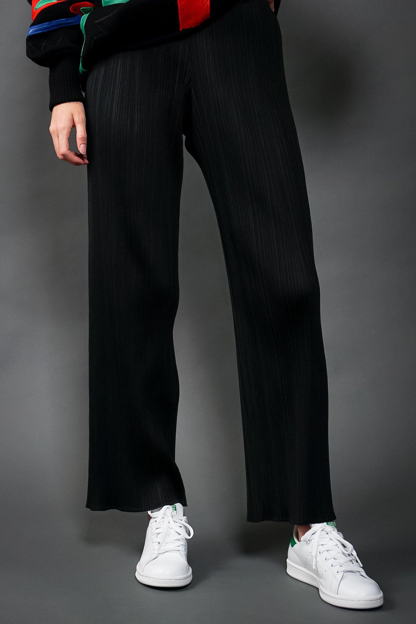 Girl in Vintage Issey Miyake Pleats Please Black Pleated Ankle Pant w/ sneakers at Recess LA