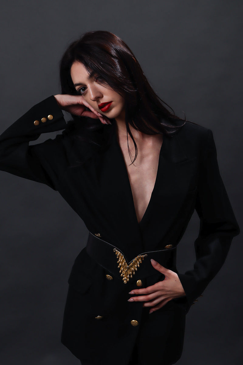 Black leather vintage wing shape belt with dripping gold V accent on model @recessla