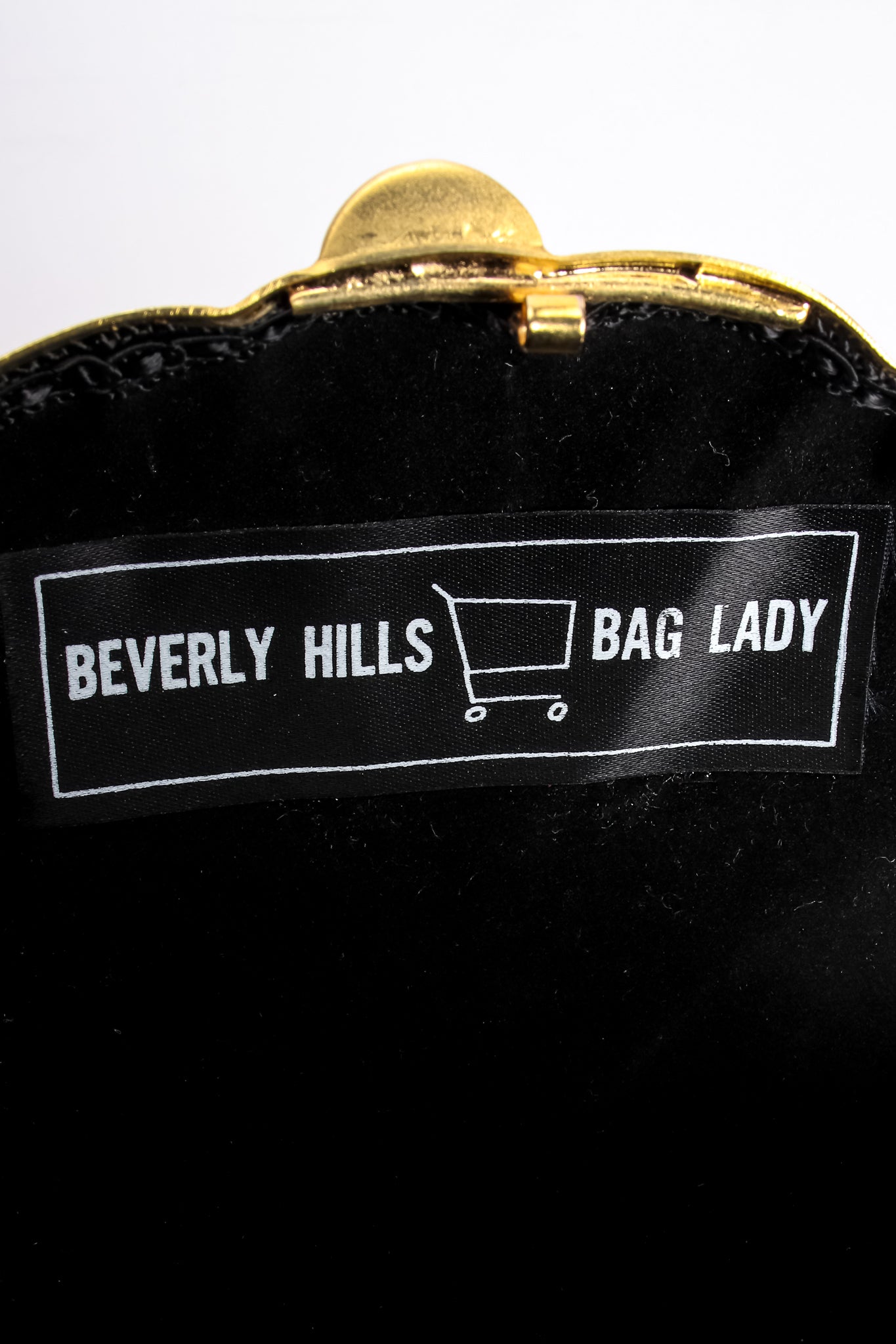 Vintage Beverly Hills Bag Lady Golden Lion Metal Clutch Bag label at Recess Los Angeles