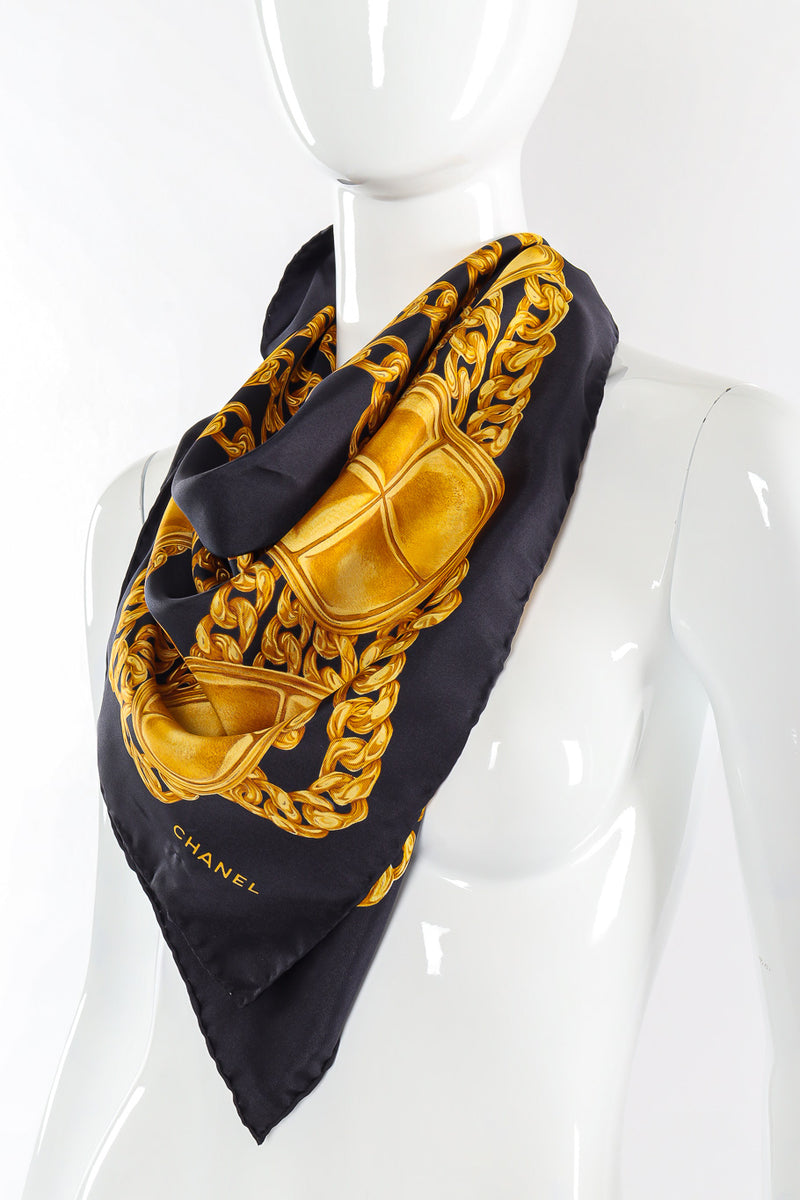 Classic chain and stud print scarf by Chanel tied on mannequin @recessla