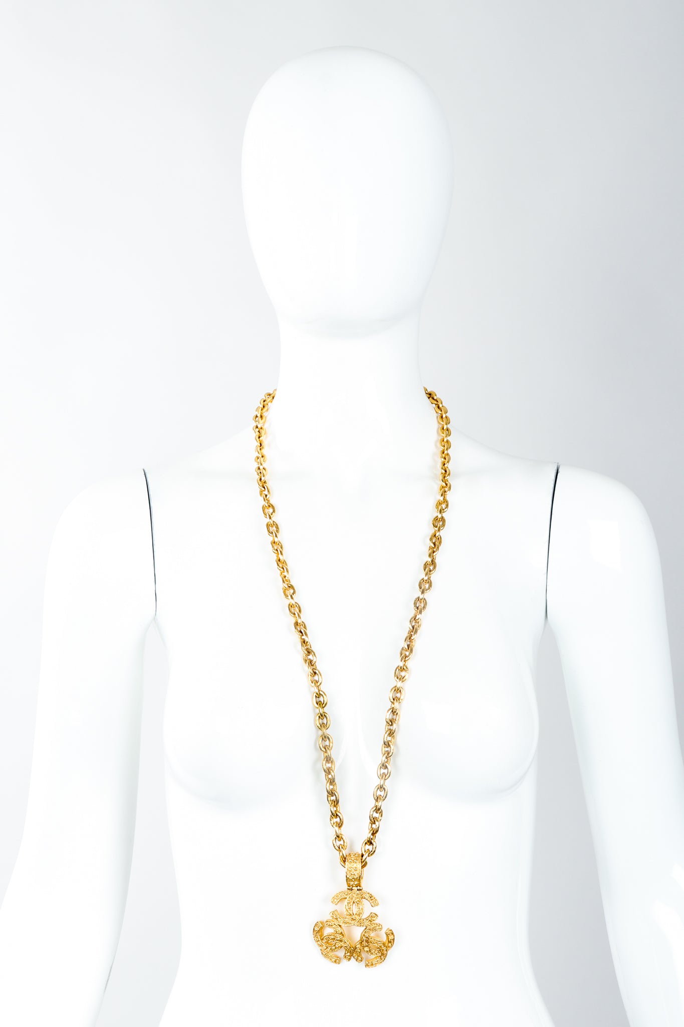 Vintage Chanel Gold Long Triple CC Logo Pendant Necklace swirled on mannequin