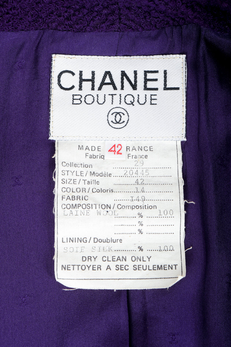Vintage Chanel bouclé jacket label on purple