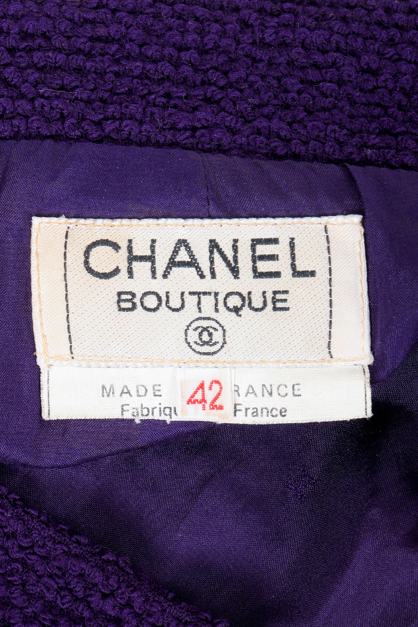 Vintage Chanel Bouclé Skirt Label on purple fabric