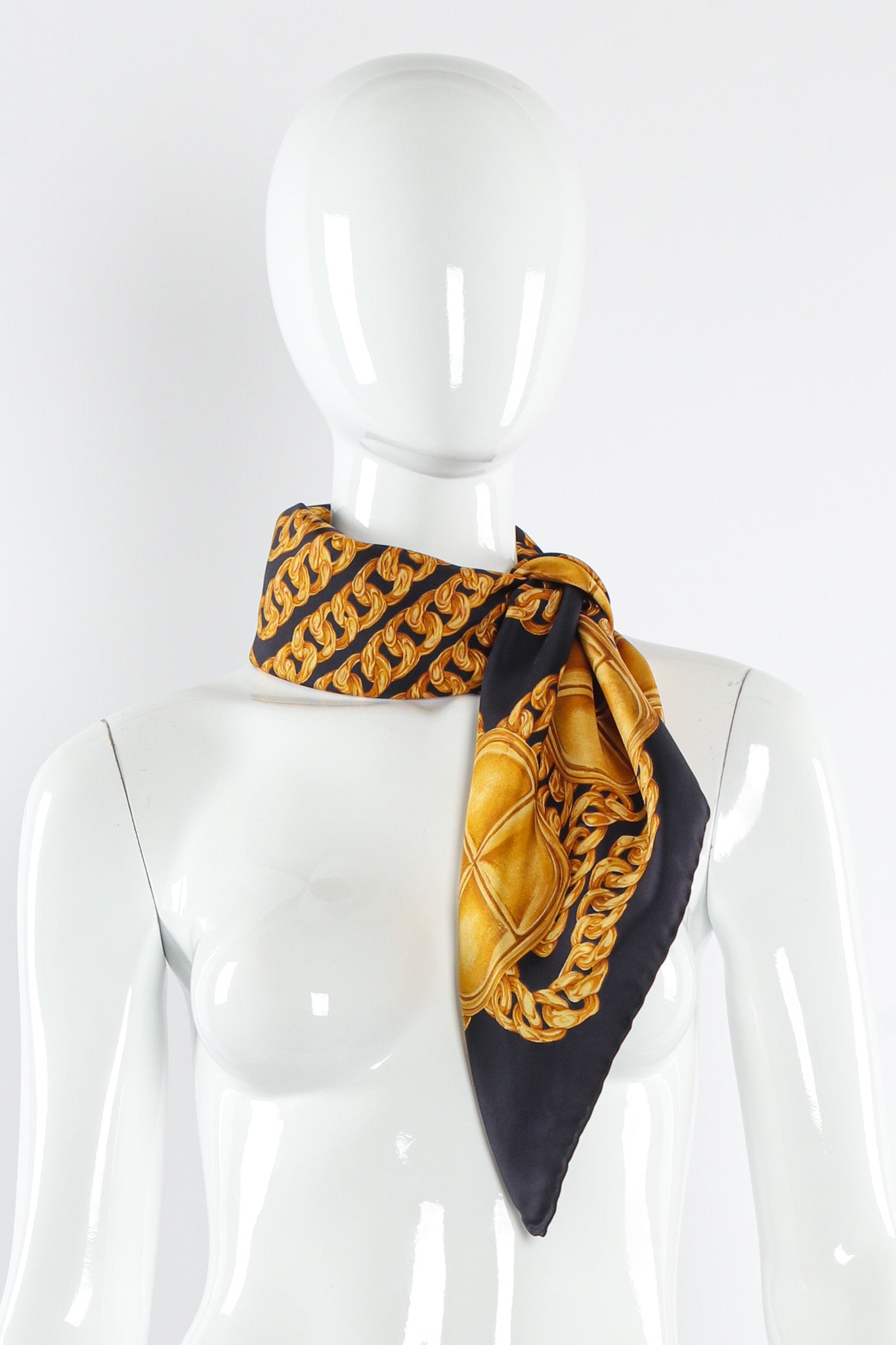 Classic chain and stud print scarf by Chanel tied on mannequin @recessla