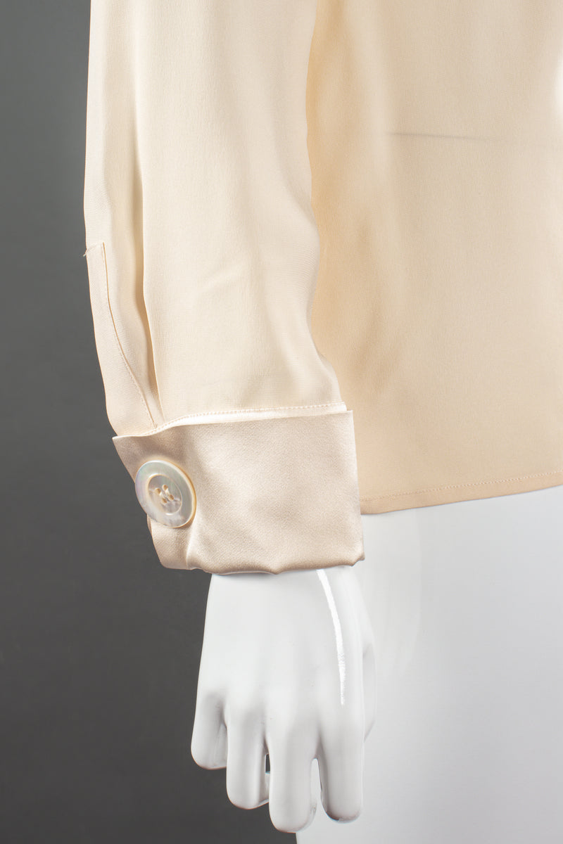 Vintage Chanel Cream Silk Panel Tuck Bow Blouse on Mannequin sleeve cuff at Recess Los Angeles